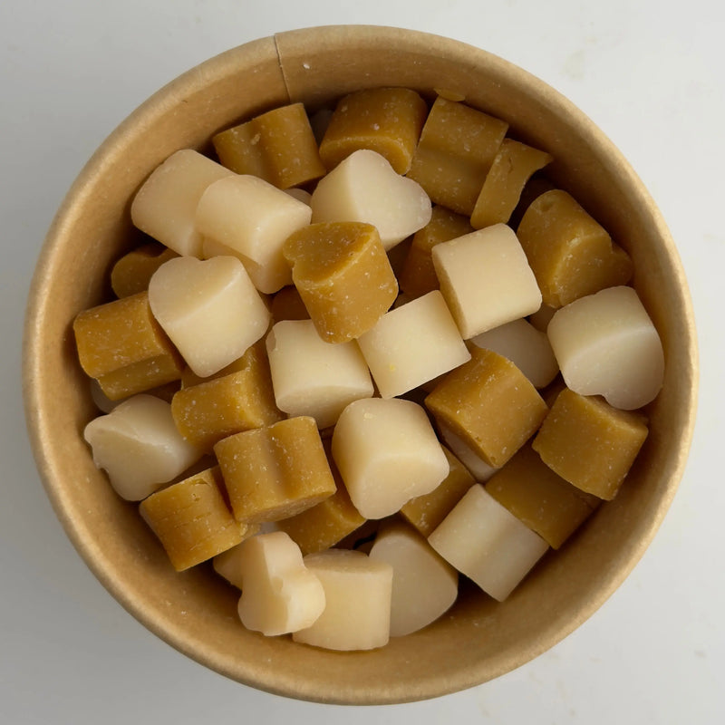 Brown and white wax melts in a cardboard bowl