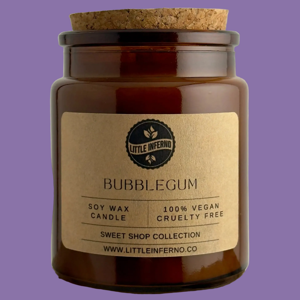 Soy wax candle in a glass jar with a cork lid on a purple background