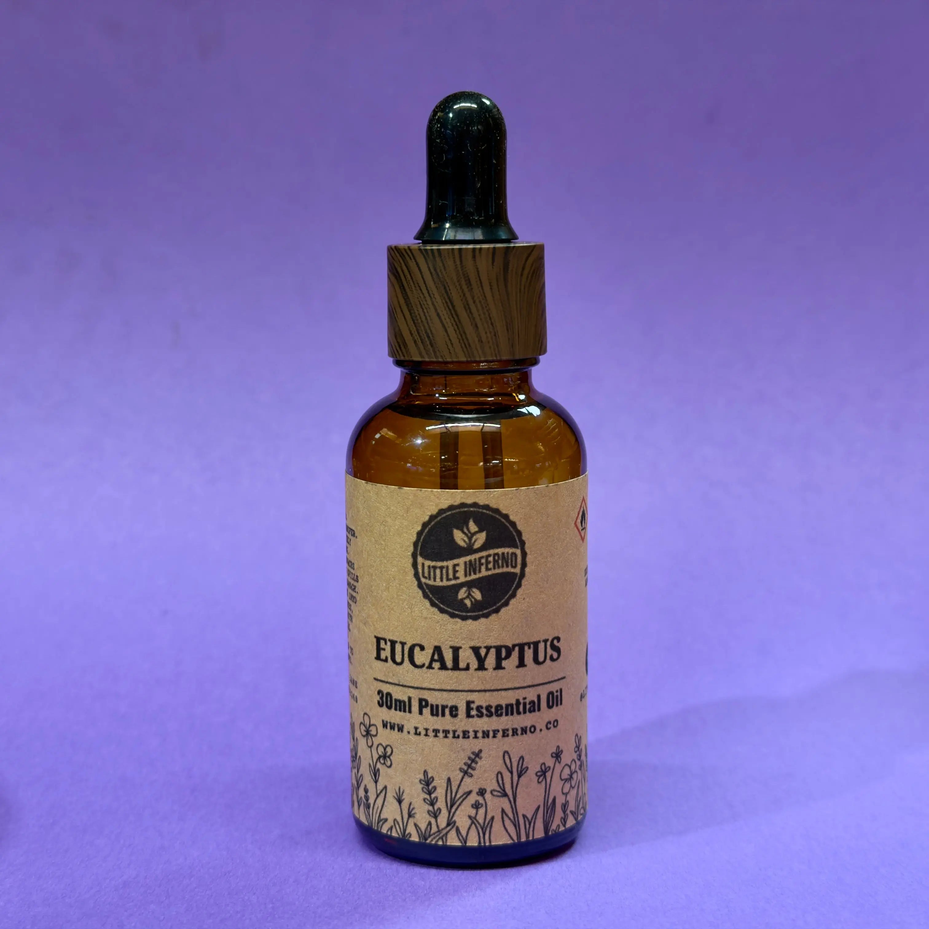 Bottle of Eucalyptus essential oil with a dropper on a purple background
