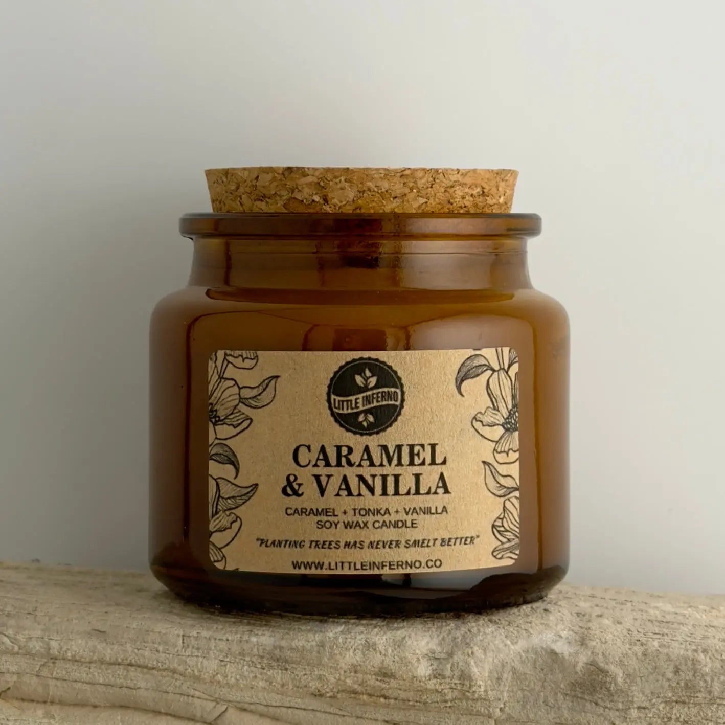Candle jar with 'Caramel & Vanilla' label on a wooden surface