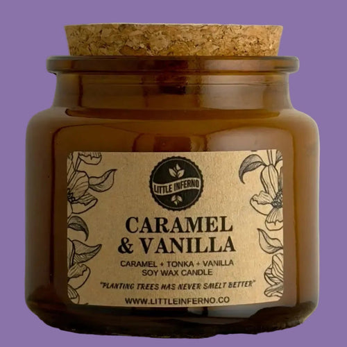Candle jar with 'Caramel & Vanilla' label on a wooden surface
