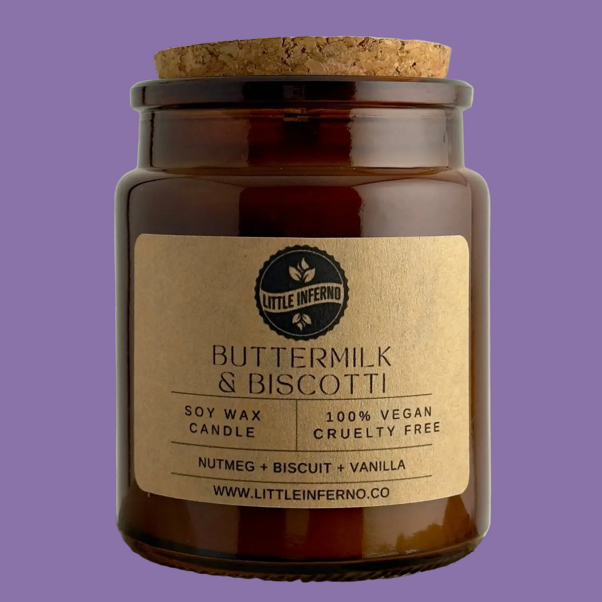 Candle jar with cork lid and 'Little Inferno' label on a purple background