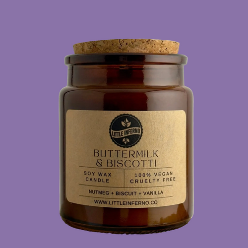 Candle jar with cork lid and 'Little Inferno' label on a purple background